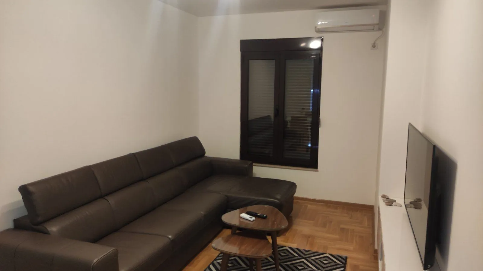 Living room with a sectional sofa, coffee table and television.