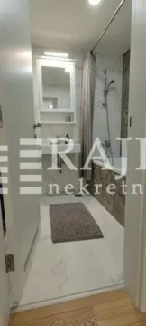 A view of a modern bathroom with a bathtub and a sink. - image 11