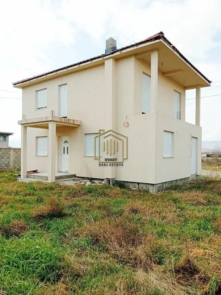 Exterior view of a two-story house with a yard.