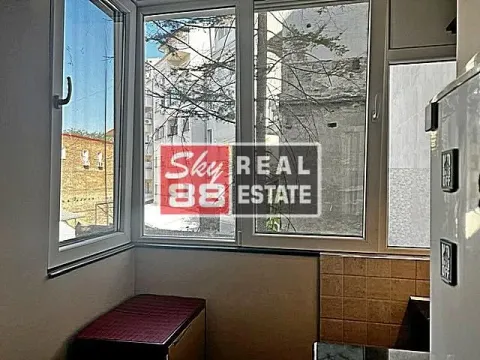 Small kitchen with windows and a view of surrounding buildings. - image 12