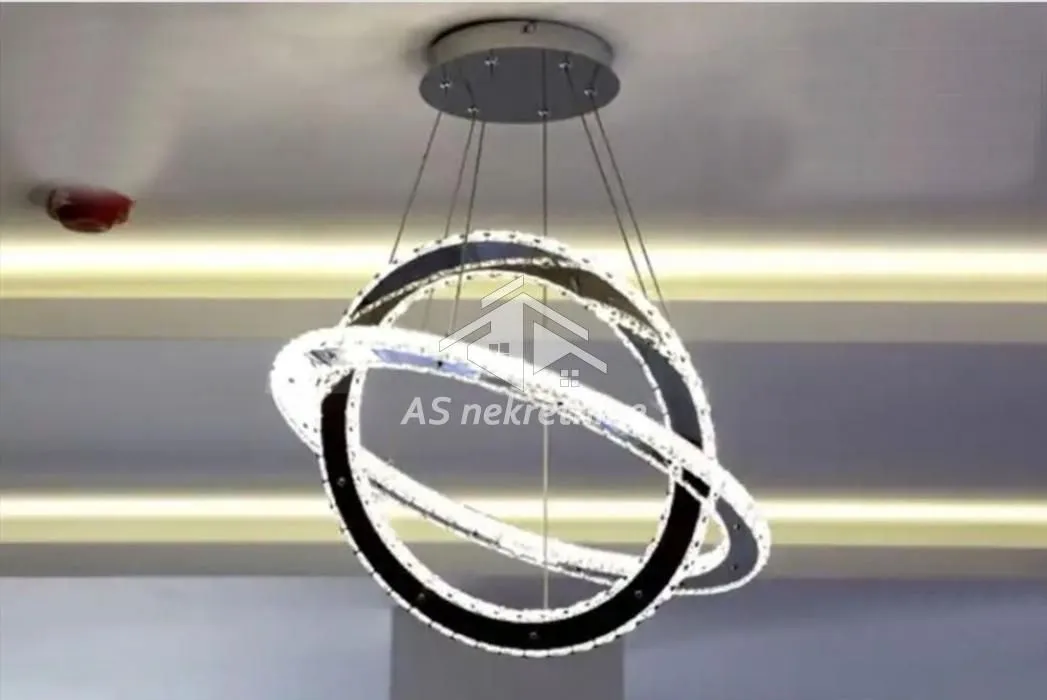 Detail of a modern pendant chandelier with circular lighting.