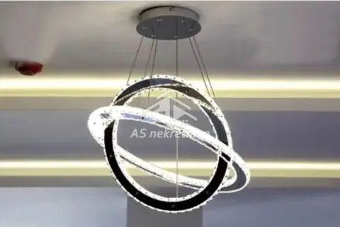 Detail of a modern pendant chandelier with circular lighting. - image 4