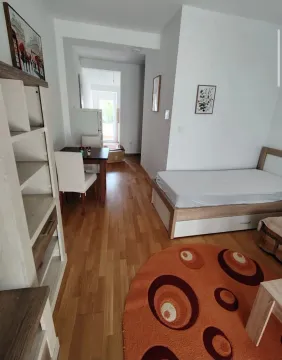 Small bedroom with a bed and a dining table in the extension. - image 3