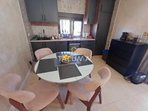 Kitchen with a dining table and chairs. - image 4