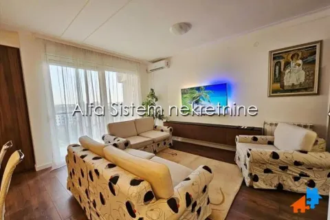 Living room with seating furniture, television, and access to the terrace. - image 3