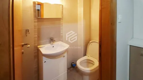Smaller bathroom with a sink, mirror, and toilet. - image 4