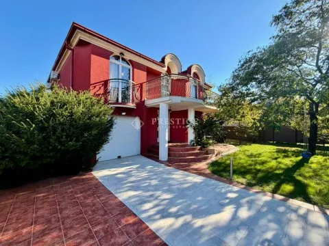 Exterior of a two-story red facade house with a yard and garage. - image 5