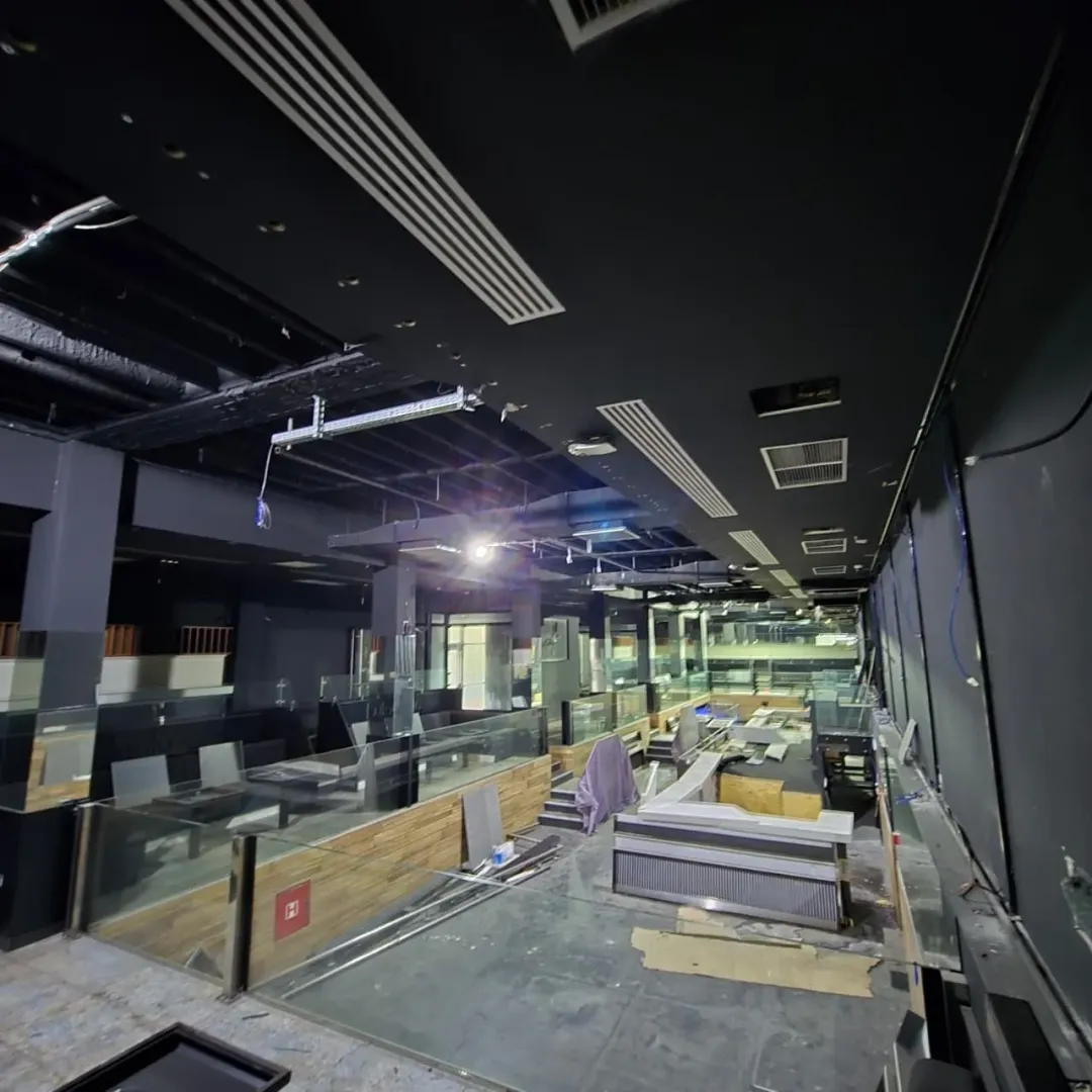 View of a larger commercial space undergoing renovation with a black ceiling.