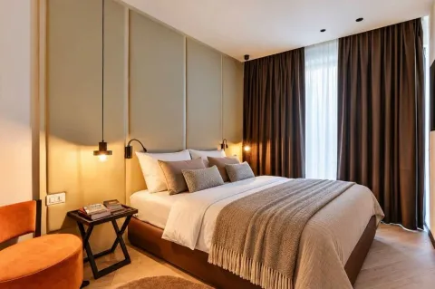 Modern bedroom featuring a double bed, bedside table, and curtains. - image 6