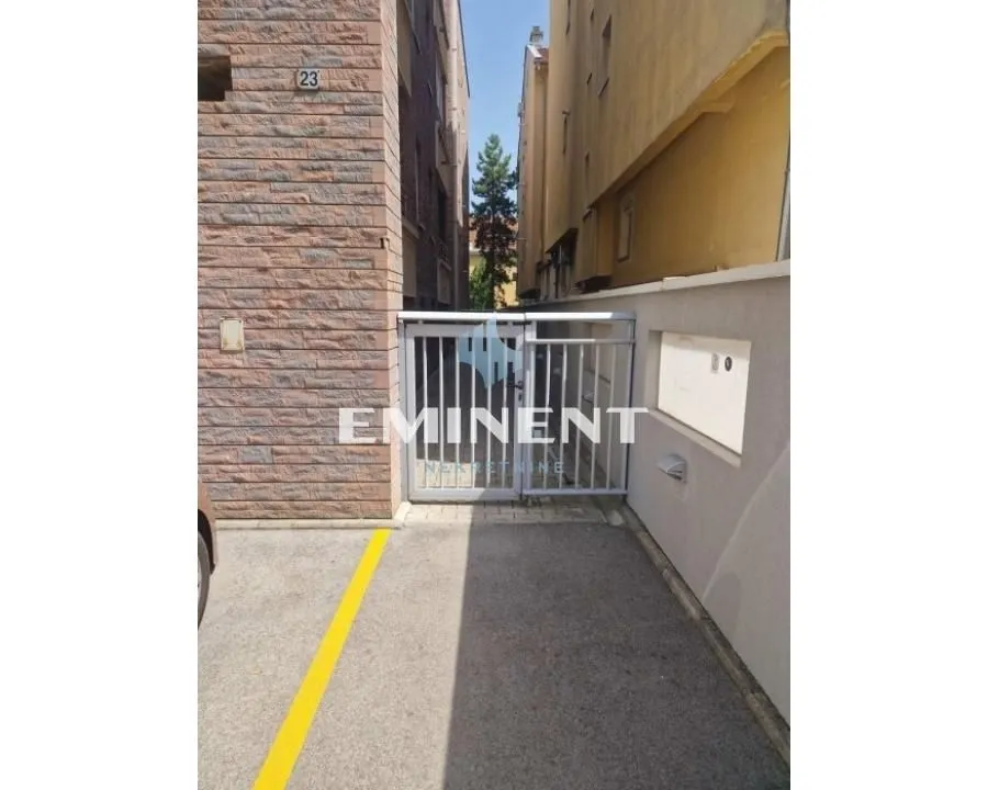 View of the building entrance and parking area.
