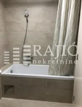 View of the bathroom with a bathtub and shower. - image 8