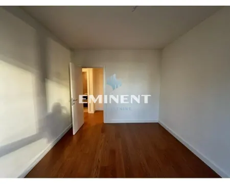 Empty room with wooden flooring and an open door. - image 12