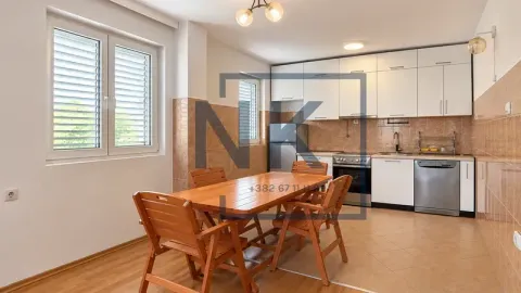 Spacious kitchen with a dining area and white cabinetry. - image 8