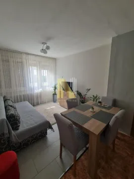 Dnevna soba sa garniturom za sedenje, trpezarijskim stolom i televizorom. - image 9