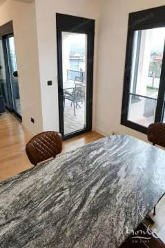 Dining area with a marble table and a view of the terrace. - image 8