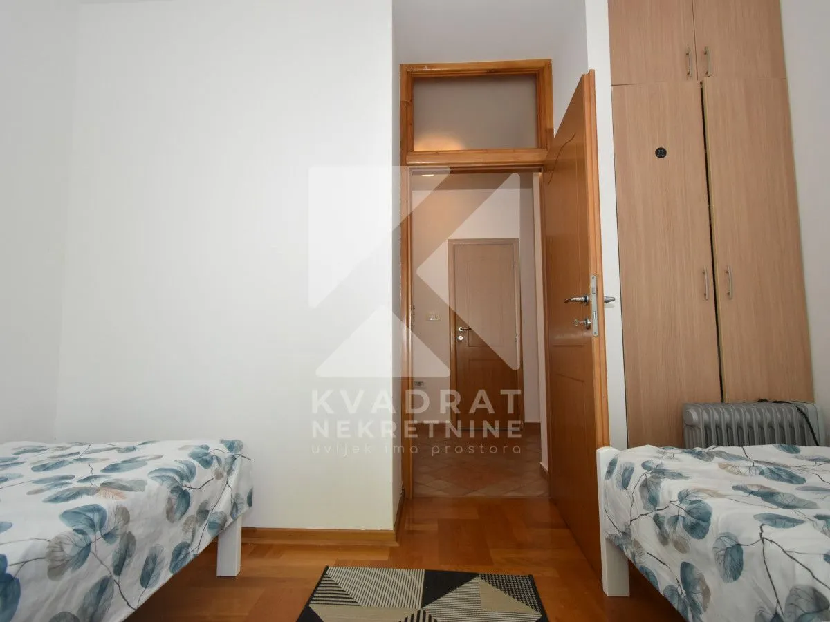 Bedroom with two single beds and a fitted wardrobe.