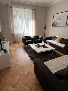 A bright living room featuring modern furniture and parquet flooring. - image 3