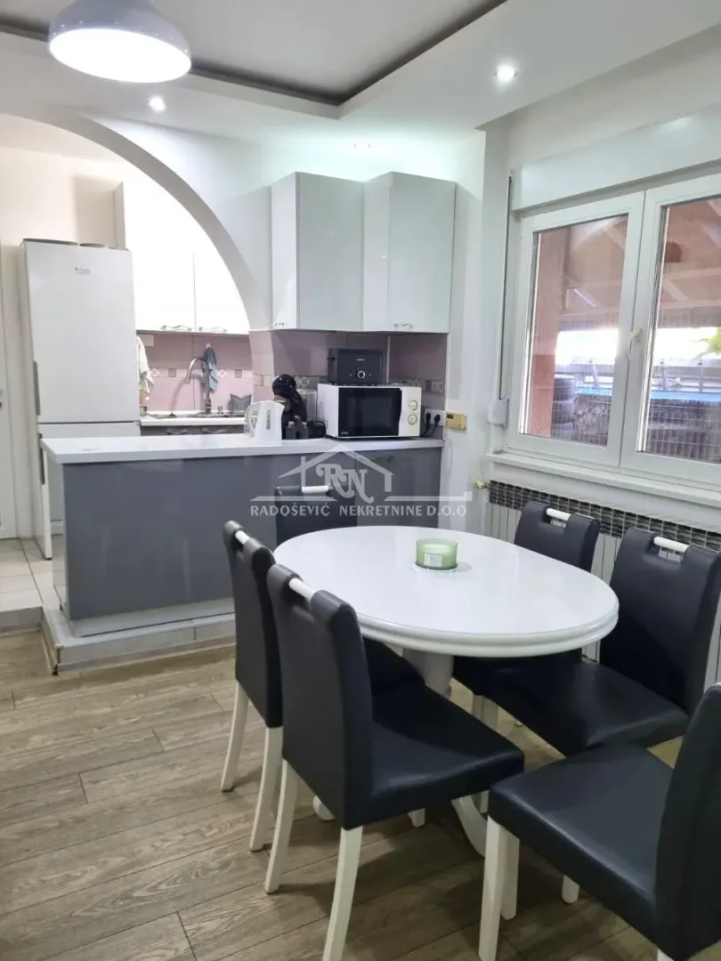Kitchen with dining area and white cabinets.