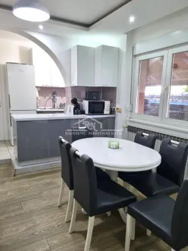 Kitchen with dining area and white cabinets. - image 4