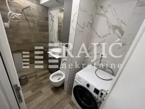Modernly equipped bathroom with a washing machine. - image 7