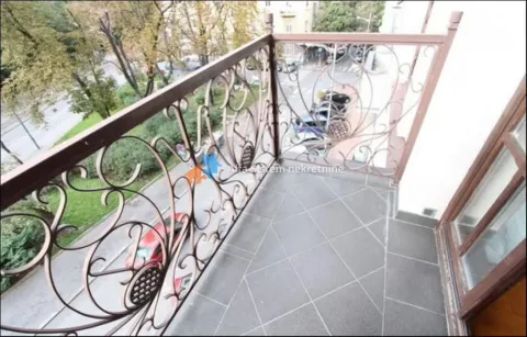 Balcony with dark floor tiles and a decorative metal railing. - image 22