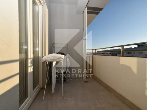 A drying rack is placed on the sunny balcony. - image 2