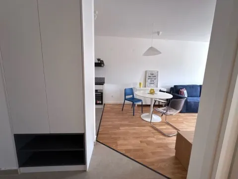 Living room with dining area and kitchen in the background. - image 5