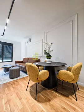Living room with a dining table and sofa. - image 6