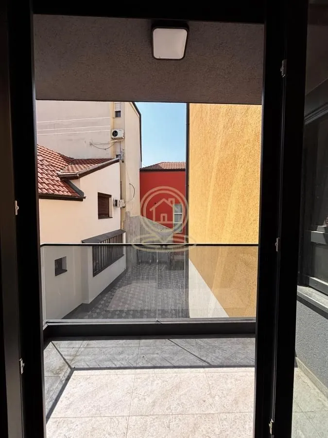 View from the balcony overlooking surrounding buildings and courtyard.