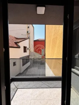 View from the balcony overlooking surrounding buildings and courtyard. - image 3