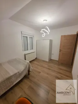 Small bedroom with a bed, wardrobe, and wooden flooring. - image 5