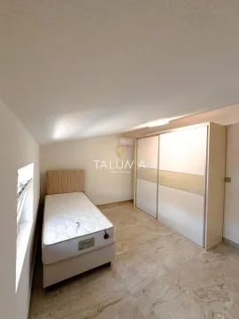 Bedroom with a bed and a large wardrobe under a sloped ceiling. - image 14