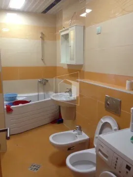 Bathroom with a bathtub, washbasin, bidet, toilet, and washing machine. - image 15