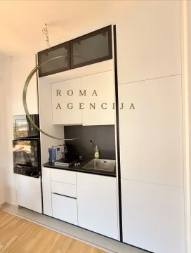 Modern white kitchen with black details and built-in appliances. - image 3