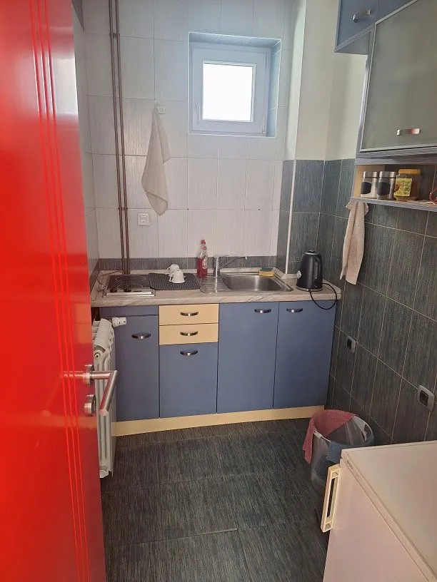 Smaller kitchen with a sink, cabinetry, and a built-in stovetop.
