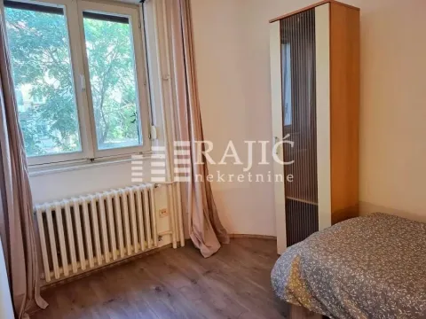 Furnished bedroom with a bed, wardrobe, and a window. - image 13