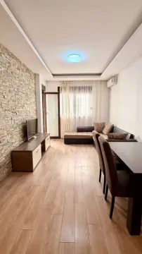 Living room with a dining area and a stone wall accent. - image 6