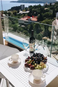 Terrace view of the sea and swimming pool with a set table for two. - image 6