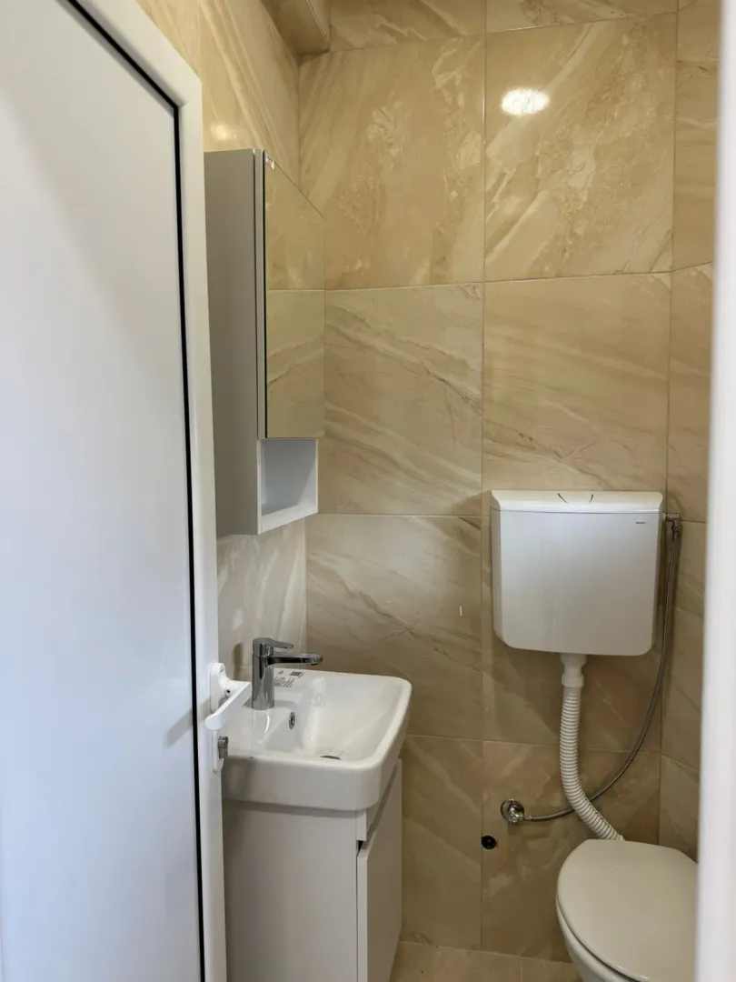 A small bathroom with a sink and toilet.