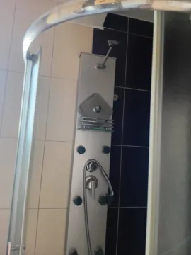 Pogled na tuš kabinu sa hidromasažnim stubom u kupatilu. - image 5