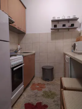 A small, functional kitchen with cabinets and appliances. - image 6