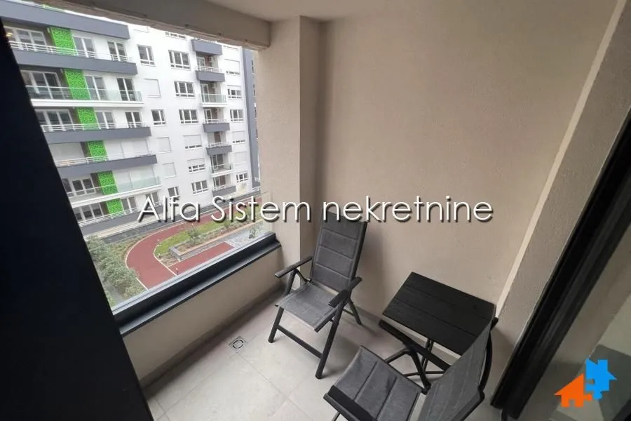 Furnished balcony with seating set and view of the neighborhood.