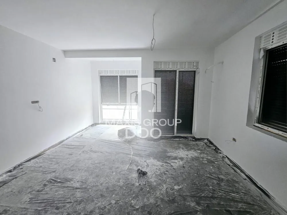 Empty room under renovation with protective foil on the floor.