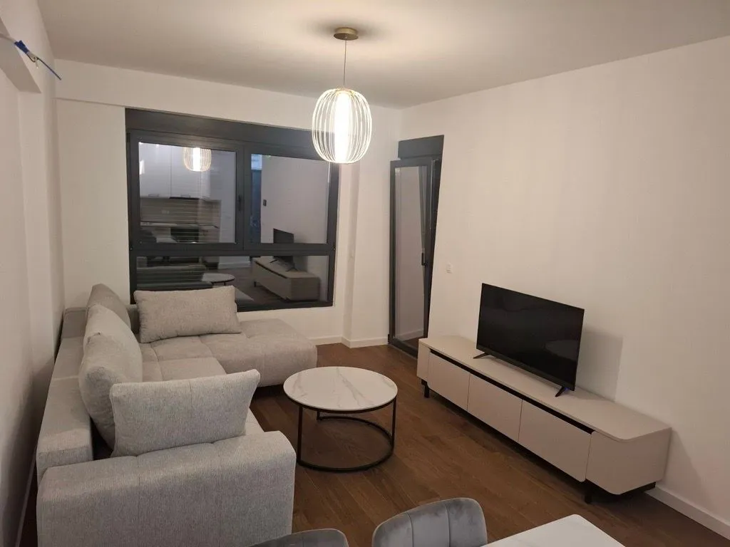 Modern living room with a sofa, coffee table, and TV.