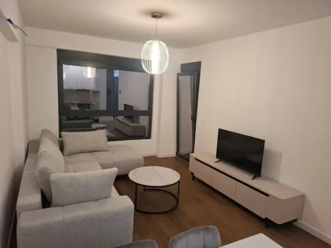 Modern living room with a sofa, coffee table, and TV. - image 2