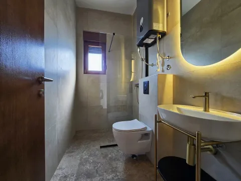 Modern bathroom with a walk-in shower, washbasin, and built-in sanitaryware. - image 15