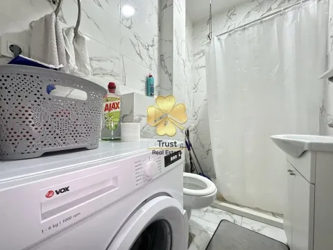 Small bathroom with a washing machine, basin, and shower cabin. - image 12