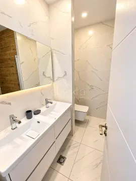 Modern bathroom with double sink and built-in sanitaryware. - image 7
