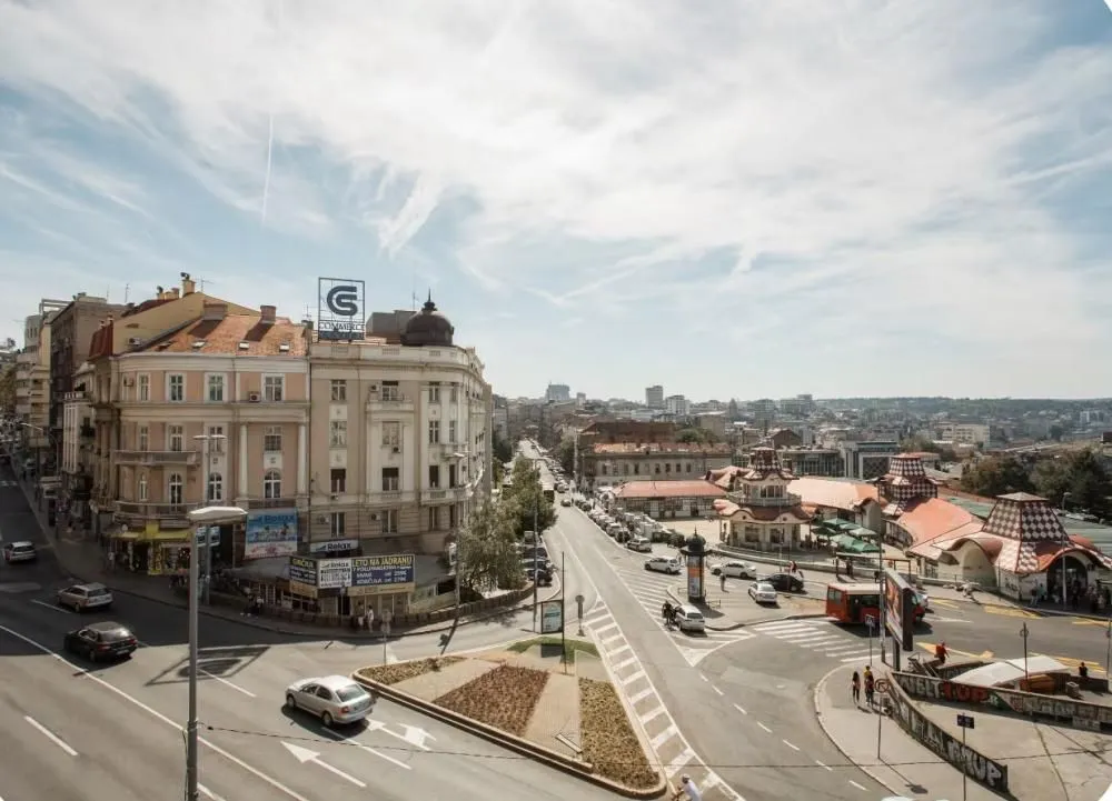 View from the window of the city street and surrounding buildings.