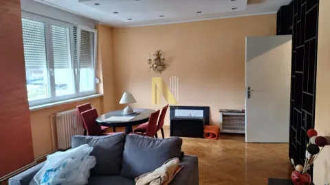 Living room with a sofa and dining table. - image 2